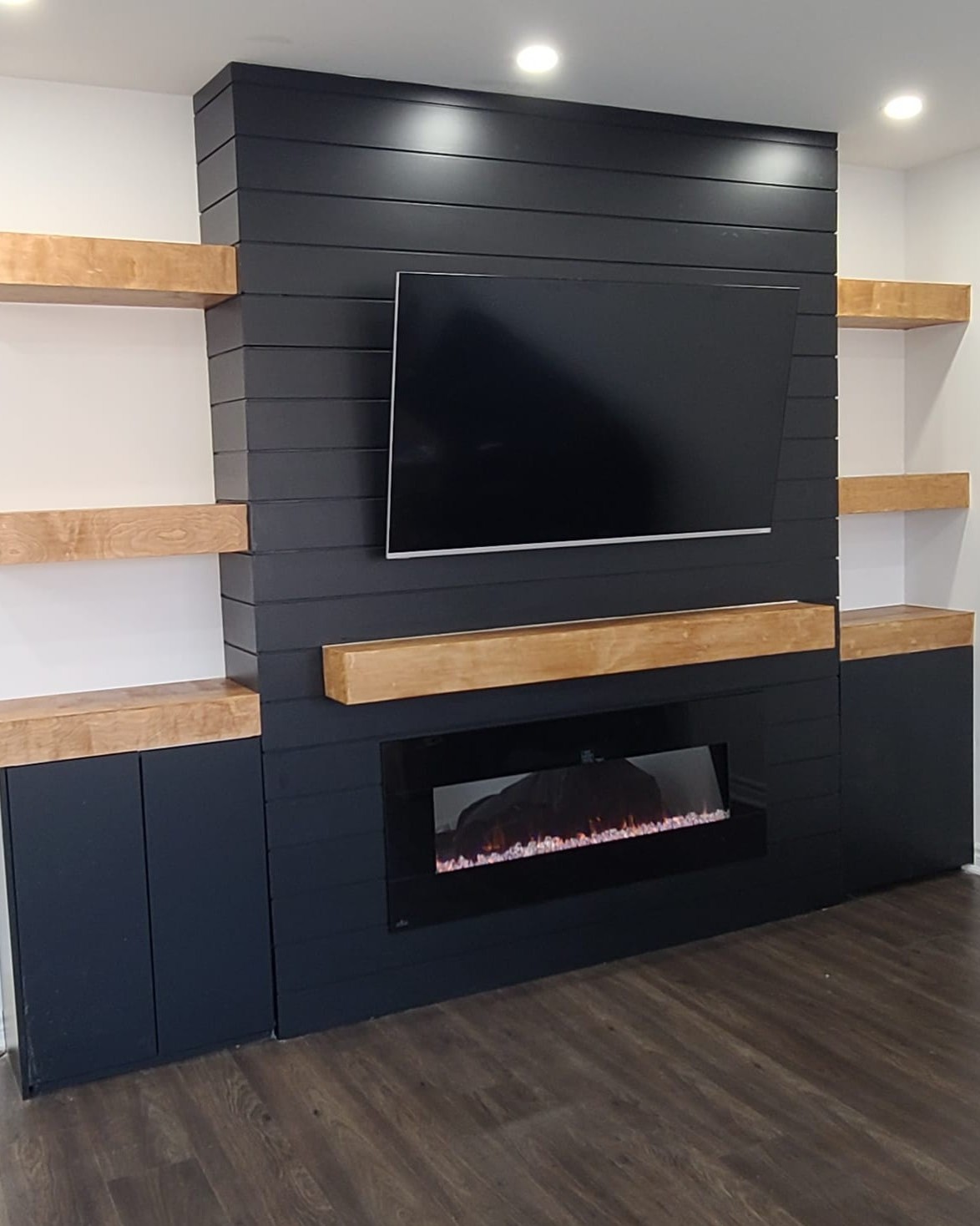 Completed modern TV wall with built-in fireplace installation in Toronto home