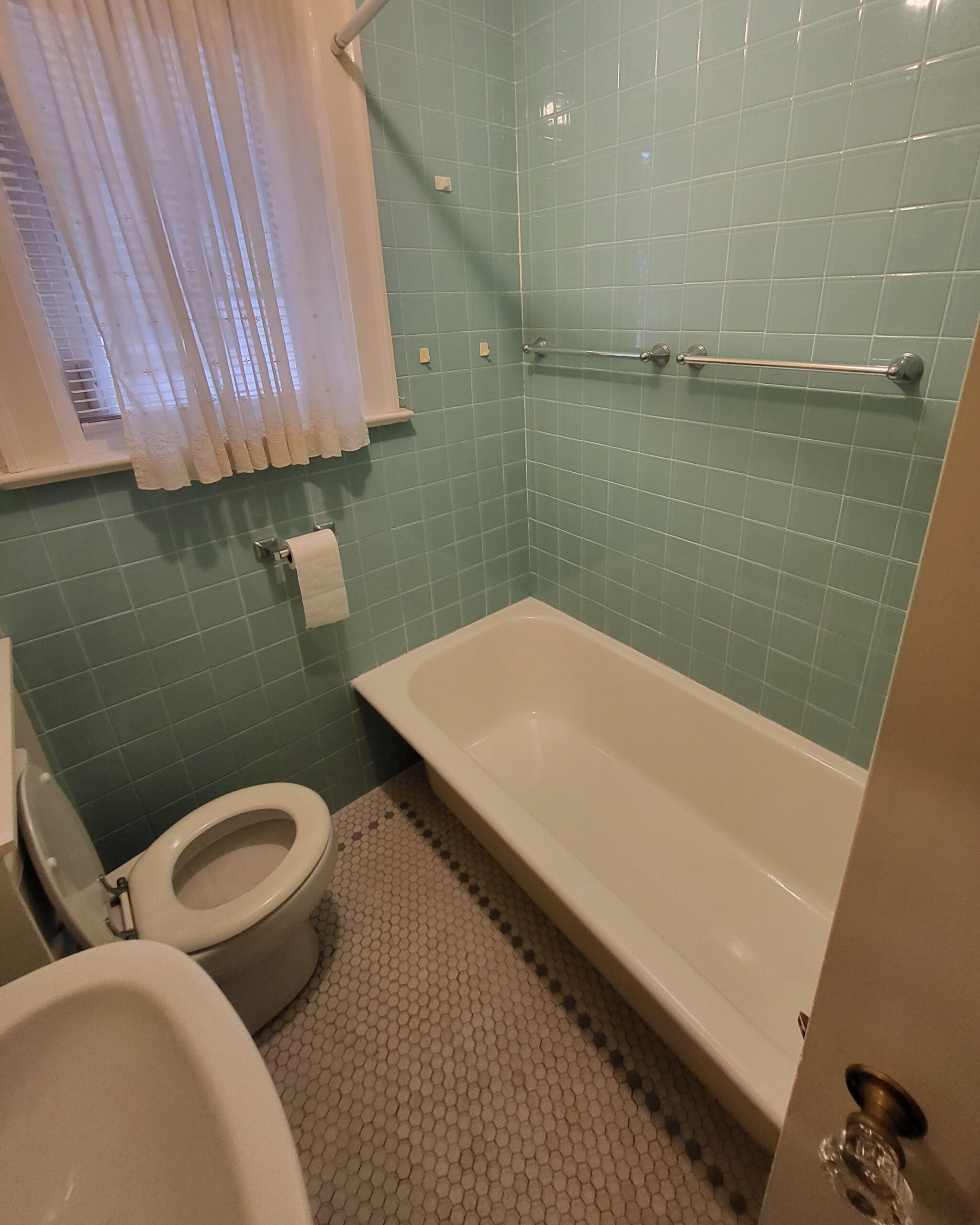Original bathroom with cast iron tub before renovation in Midtown Toronto