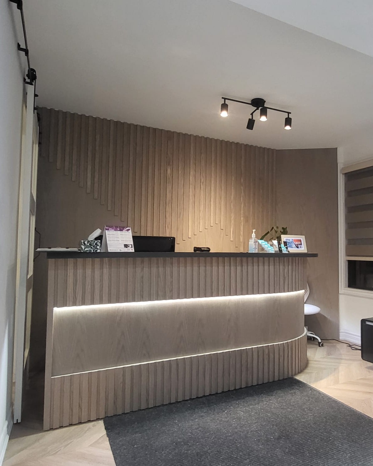 Renovated clinic area with natural wood finishes and LED lighting in Toronto
