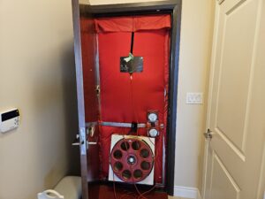 Blower door assembly installed in a doorway for air pressure testing