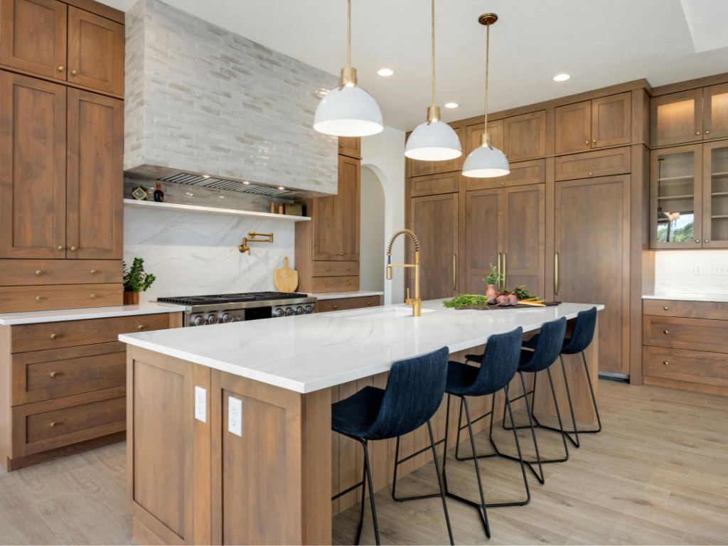  A kitchen design featuring dark wood cabinets, stone countertops, and warm ambient lighting








