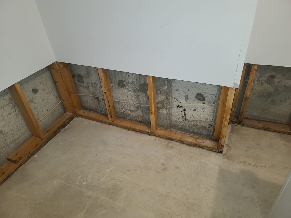 Basement foundation wall exposed after removing drywall and insulation for inspection