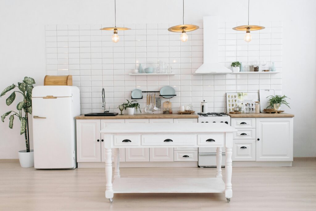 Modern kitchen renovation with white cabinets and oak flooring in Toronto