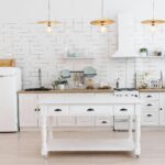 Modern kitchen renovation with white cabinets and oak flooring in Toronto