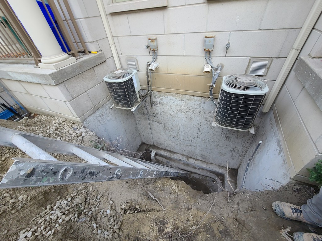 Foundation wall sandblasted to achieve proper surface profile for effective waterproofing membrane adhesion