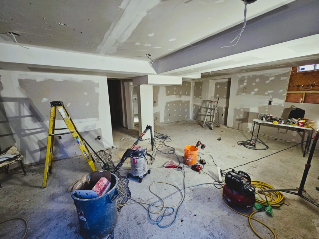 Basement under construction in a Toronto home with exposed framing and insulation