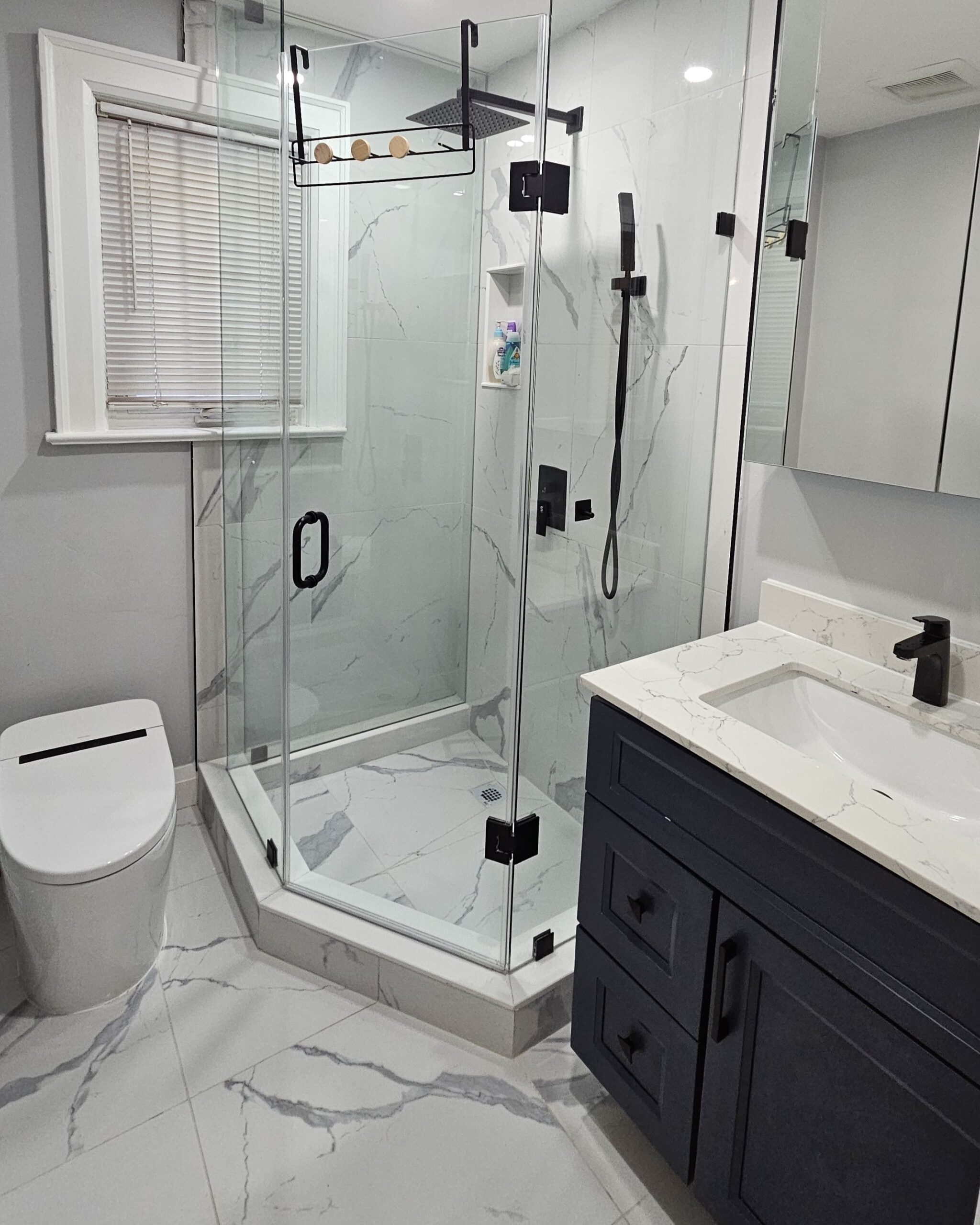 Modern newly renovated bathroom with sleek fixtures, tiled walls, and a clean contemporary design