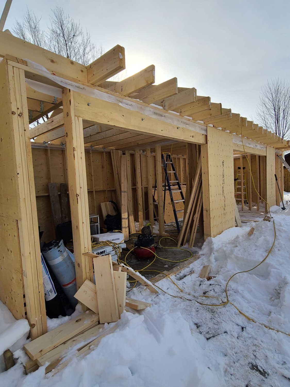 Raft slab foundation poured with framing being installed for custom cabana house construction in Central Ajax.