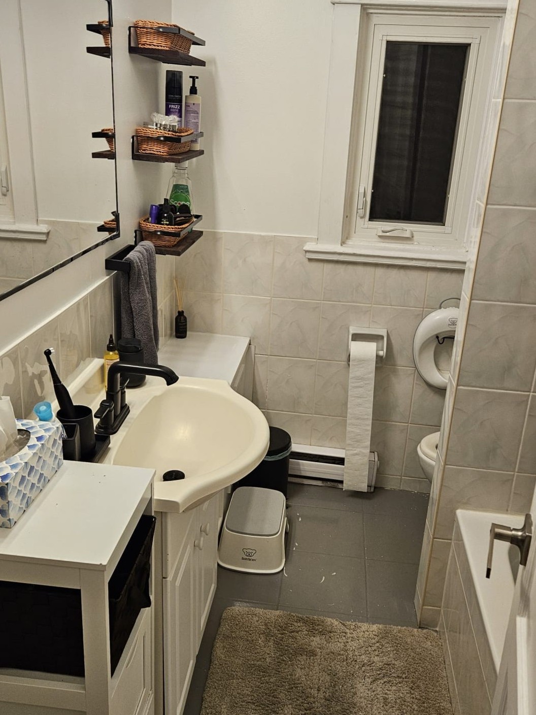 Before photo of an outdated bathroom with old finishes and an impractical layout requiring a full redesign and renovation.