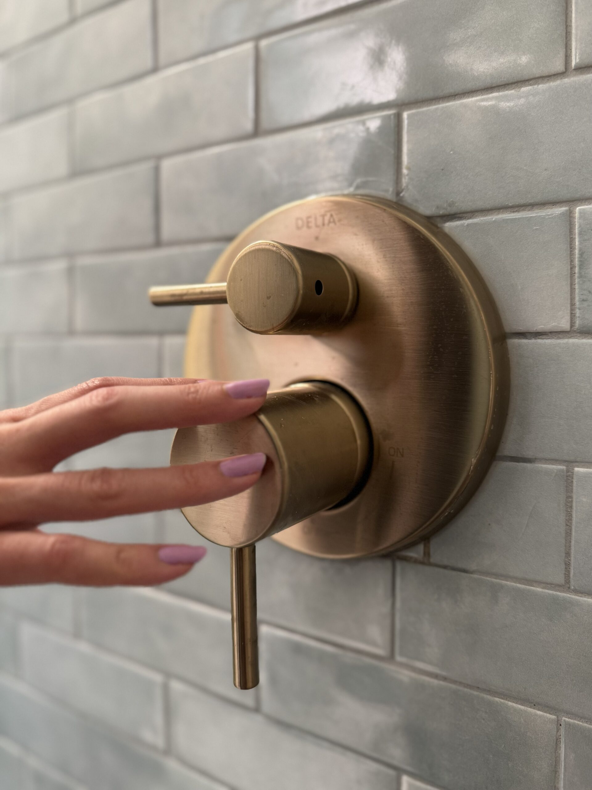 delta-brushed-brass-shower-valve-grey-subway-tile-toronto
