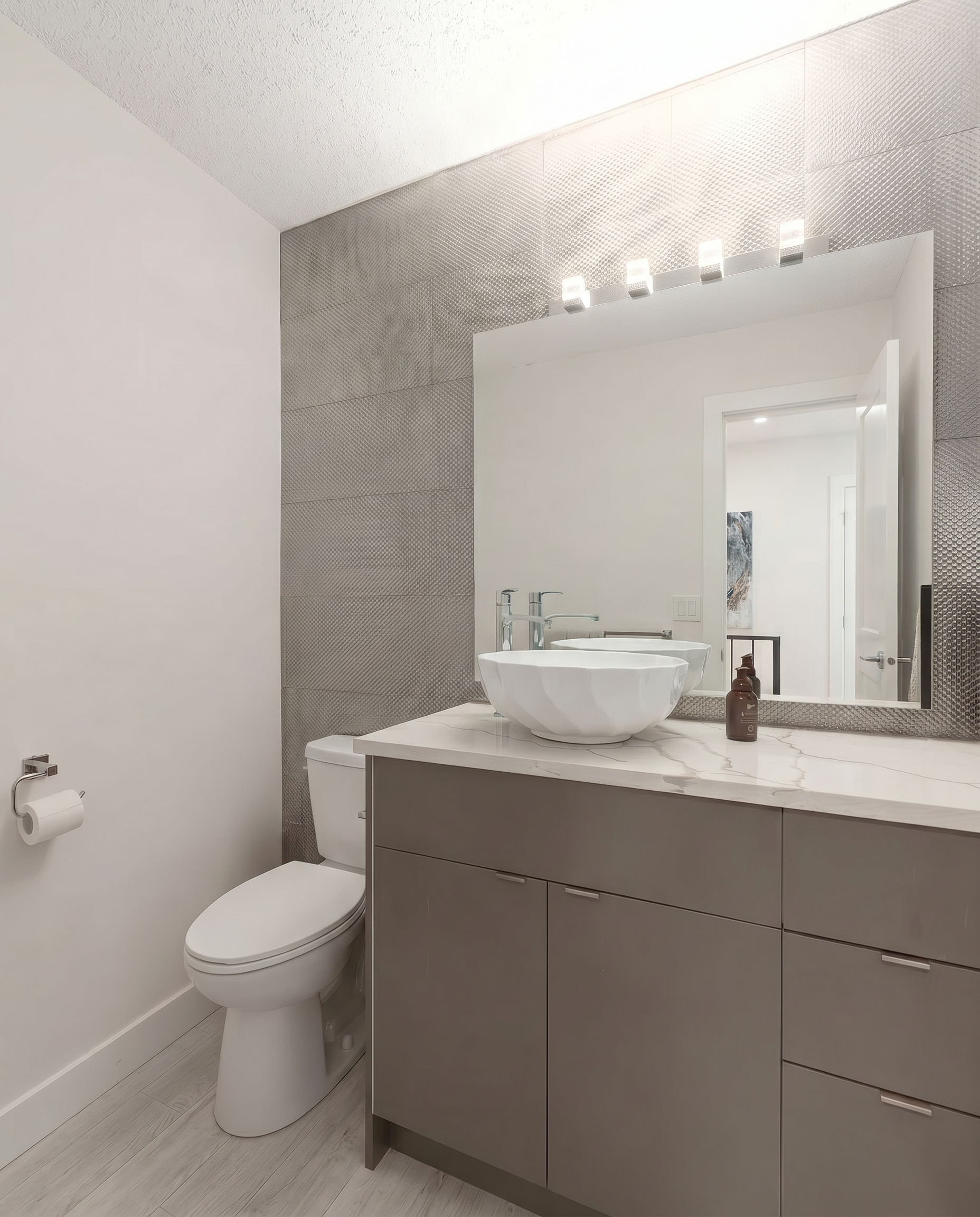 Contemporary bathroom renovation with quartz countertop, custom vanity, and upgraded lighting in North York, ON