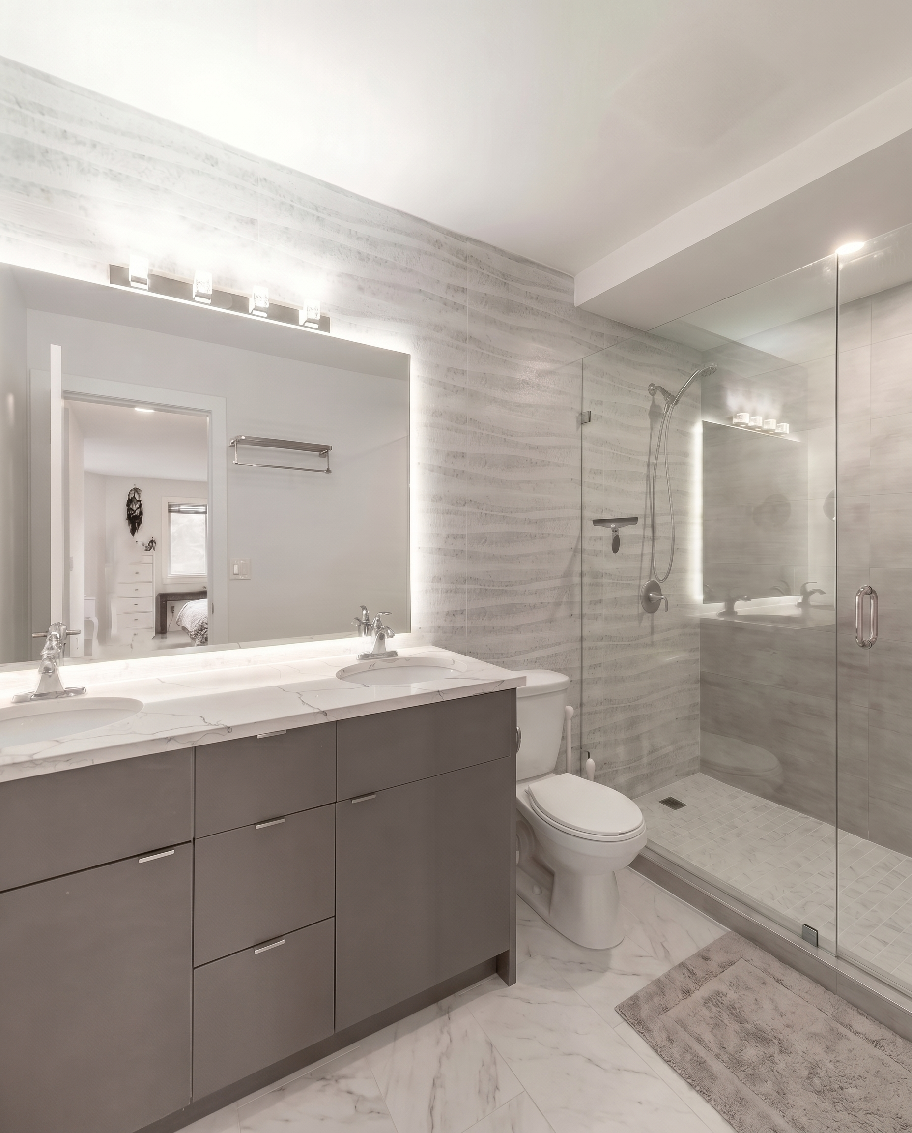 Contemporary bathroom renovation with quartz countertop, custom vanity, and upgraded lighting in North York, ON